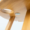 Abstract Foldable Picnic Table with a close-up view of the wooden structure and cup holder design.