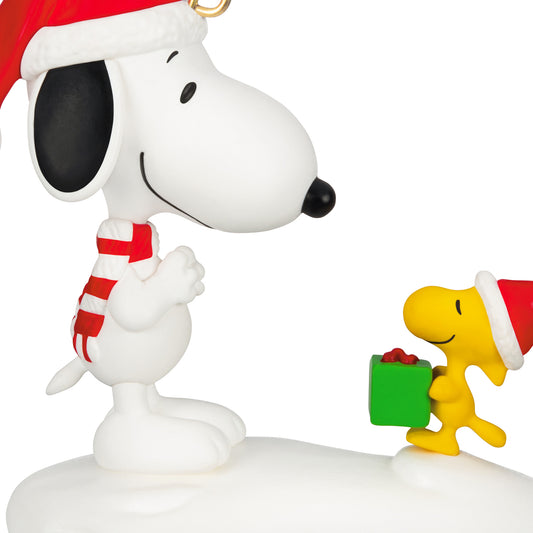 Peanuts® Spotlight on Snoopy The Perfect Gift, 29th in the Series — 2026 Hallmark Keepsake Christmas Ornament featuring Snoopy and Woodstock in Santa hats, close up on snow.