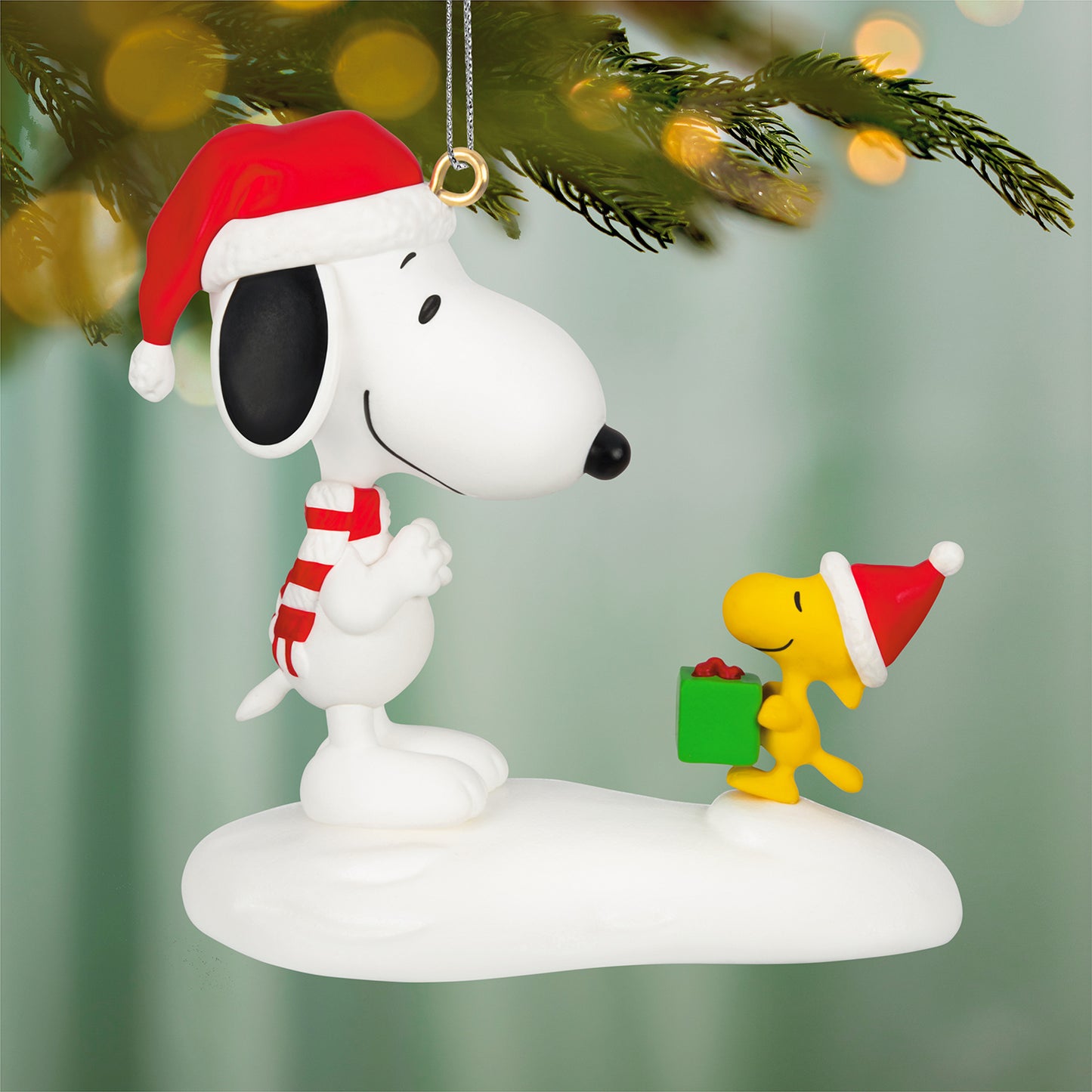 Peanuts® Spotlight on Snoopy The Perfect Gift, 29th in the Series — 2026 Hallmark Keepsake Christmas Ornament, Snoopy and Woodstock in Santa hats on snow.