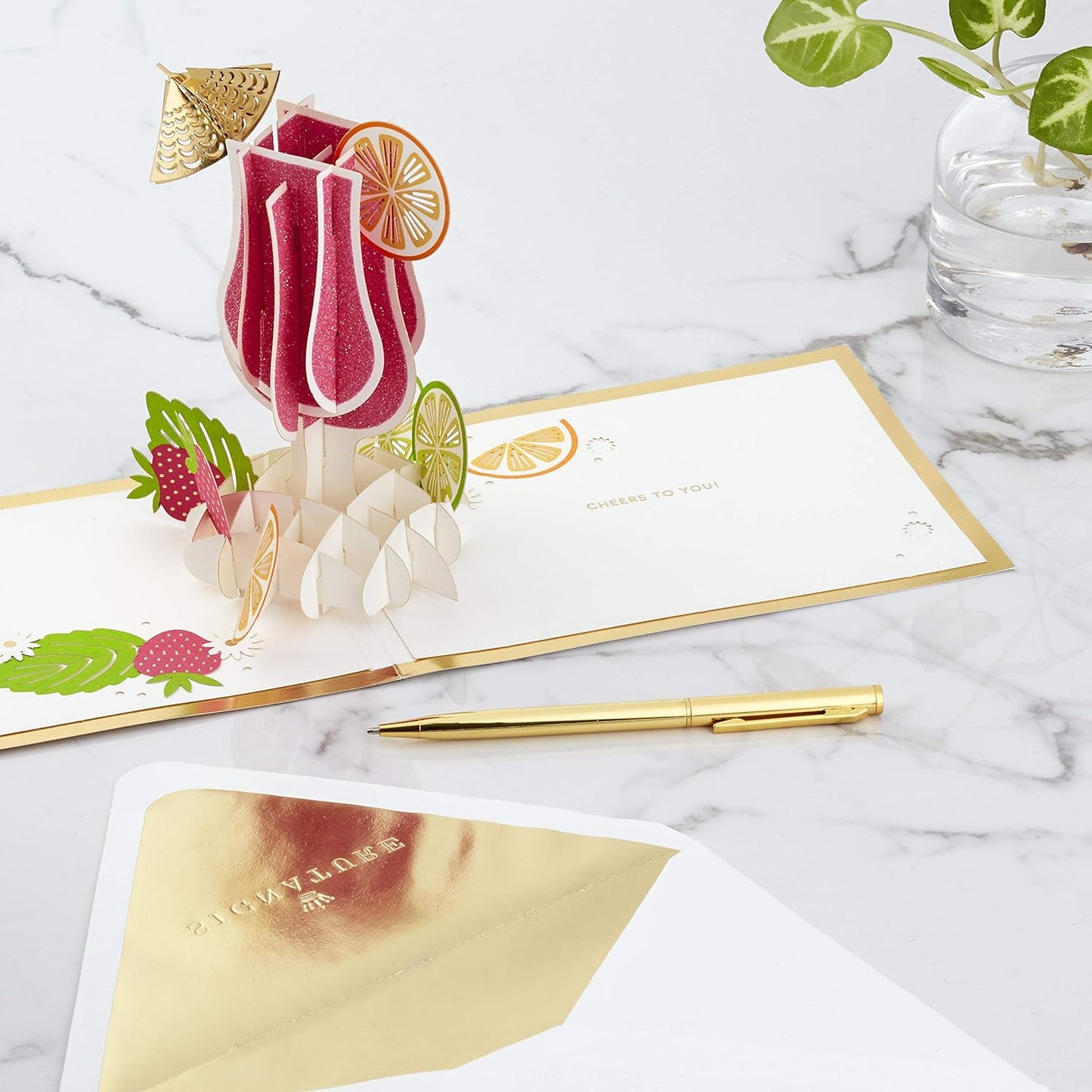 Hallmark Signature Paper Wonder Pop Up Congratulations Card, Birthday Card, College Graduation Card (Cheers, Tropical Drink) featuring an intricate pop-up tropical drink design with fruit details.