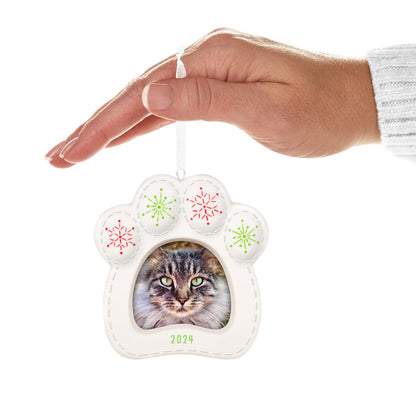 Pretty Kitty Photo Frame (Porcelain) — Hallmark Keepsake Christmas Ornament, paw-print design with red and green snowflakes, hand-held vertical view.