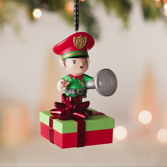 Elf Security Peekbuster With Motion-Activated Sound and Light — 2026 Hallmark Keepsake Christmas Ornament on a green and red gift.