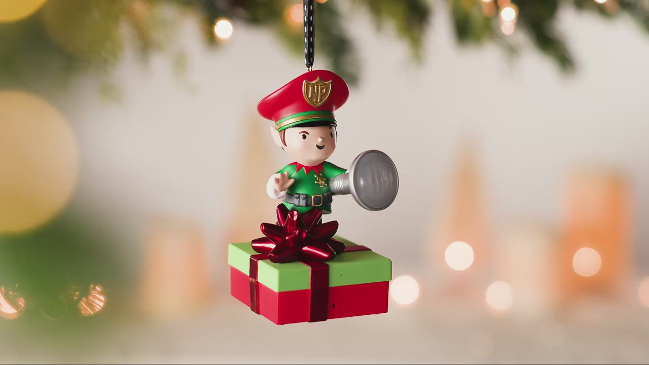 Elf Security Peekbuster With Motion-Activated Sound and Light — 2026 Hallmark Keepsake Christmas Ornament on a green and red gift.