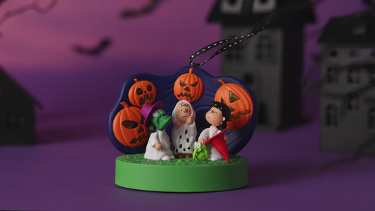 The Peanuts® Gang 60th Anniversary Spooked Trick-or-Treaters With Light and Sound — 2026 Hallmark Keepsake Halloween Ornament featuring Linus and friends with jack-o'-lanterns in a festive setting.