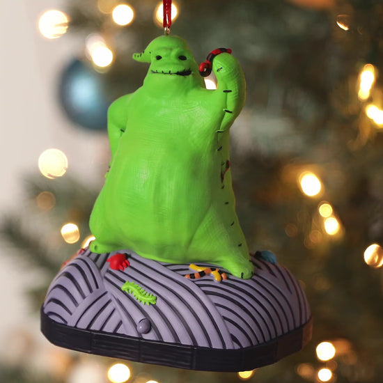 Disney Tim Burton's The Nightmare Before Christmas, Oogie Boogie With Sound and Motion — Hallmark Keepsake Christmas Ornament, close up with festive bokeh.