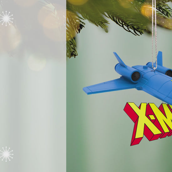 Marvel Studios X-Men ’97 The Blackbird With Sound — 2026 Hallmark Keepsake Christmas Ornament, blue jet with X-Men logo, hanging from a Christmas tree.
