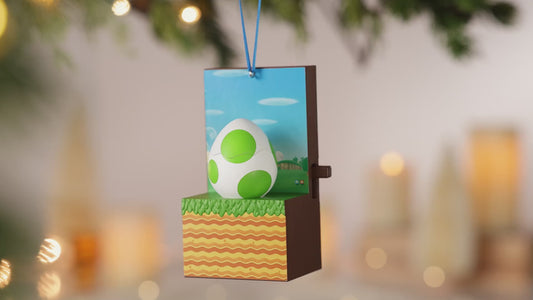 Nintendo Super Mario™ It's Yoshi! With Sound and Motion — 2026 Hallmark Keepsake Christmas Ornament, close up of Yoshi's egg design with green spots and a festive background.