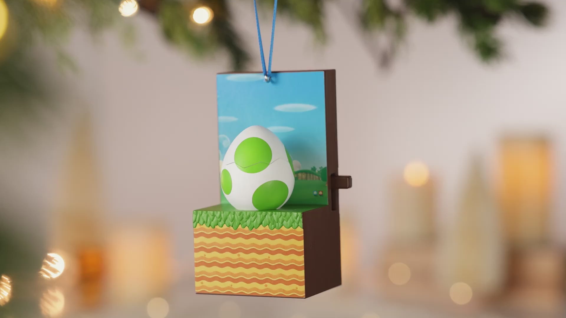 Nintendo Super Mario™ It's Yoshi! With Sound and Motion — 2026 Hallmark Keepsake Christmas Ornament, close up of Yoshi's egg design with green spots and a festive background.