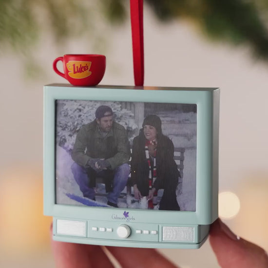 Gilmore Girls With Light and Sound — 2026 Hallmark Keepsake Christmas Ornament, featuring a retro TV design with Luke's Diner mug, hand-held.