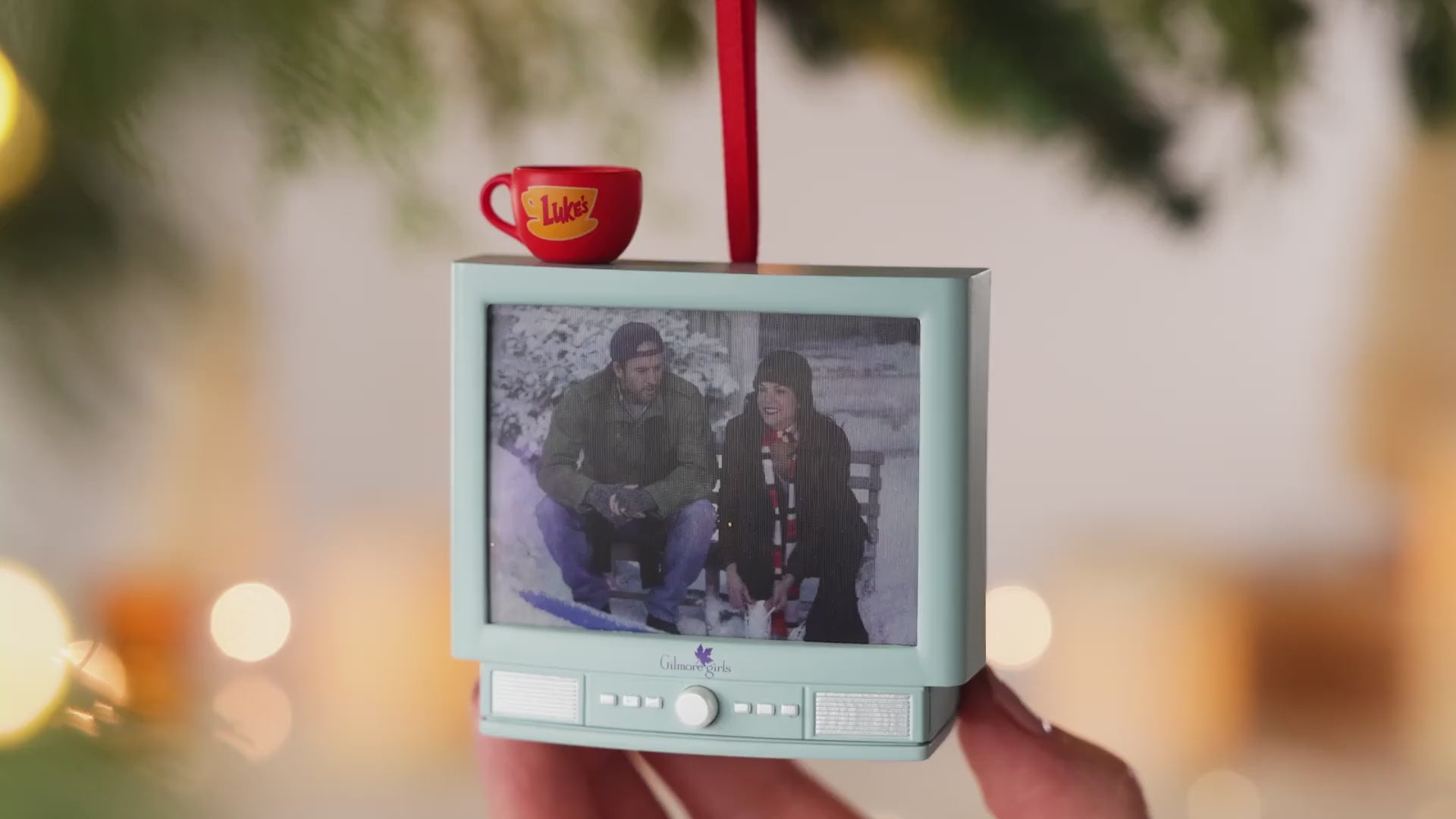 Gilmore Girls With Light and Sound — 2026 Hallmark Keepsake Christmas Ornament, featuring a retro TV design with Luke's Diner mug, hand-held.