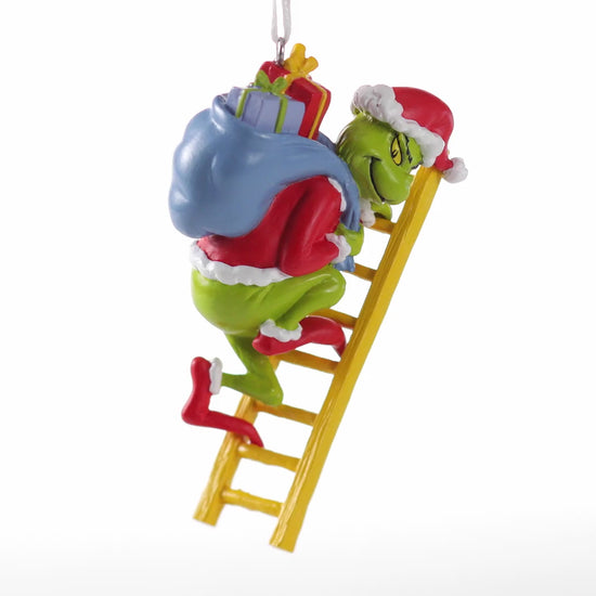 Hallmark Christmas Ornament - Dr. Seuss's How the Grinch Stole Christmas! features the Grinch on a ladder with stolen presents.