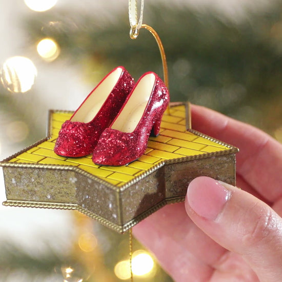 The Wizard of Oz™ There's No Place Like Home™ — Hallmark Keepsake Christmas Ornament with sparkling Ruby Slippers on a star-shaped platform.