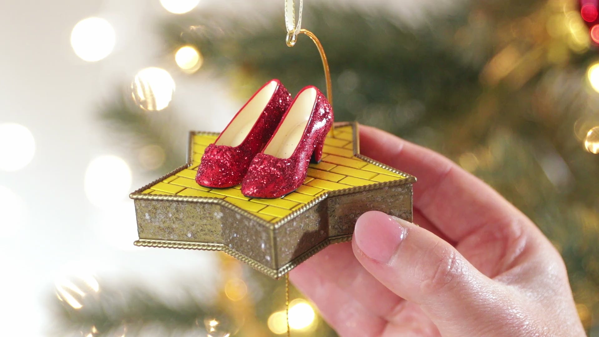 The Wizard of Oz™ There's No Place Like Home™ — Hallmark Keepsake Christmas Ornament with sparkling Ruby Slippers on a star-shaped platform.