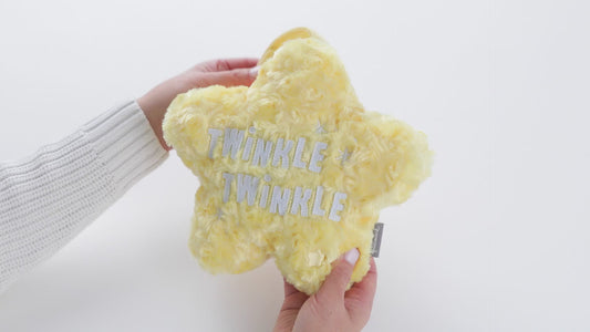 Twinkle Twinkle Musical Star Plush, yellow soft toy with shiny lettering, held in hands against a white background.