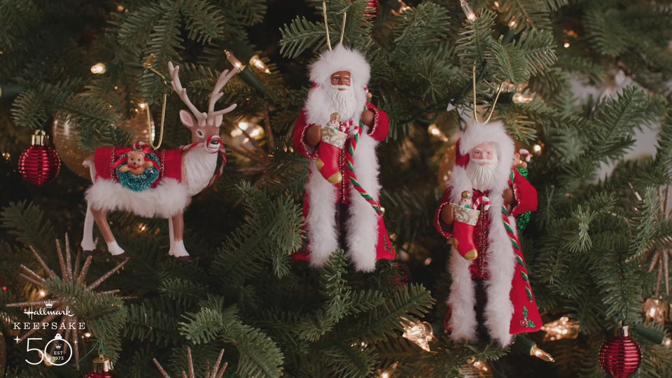Father Christmas — Hallmark Keepsake Christmas Ornament with detailed clothing, featuring two Santa figures and a reindeer, hanging on a festive tree.