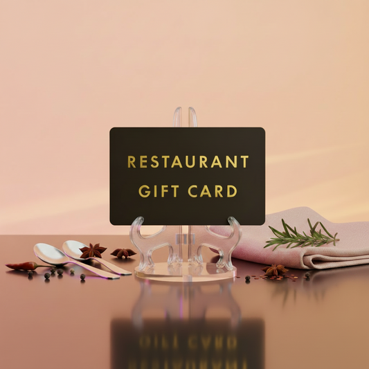 The Restaurant Gift Card displayed on a stand with spoons and herbs in the background.