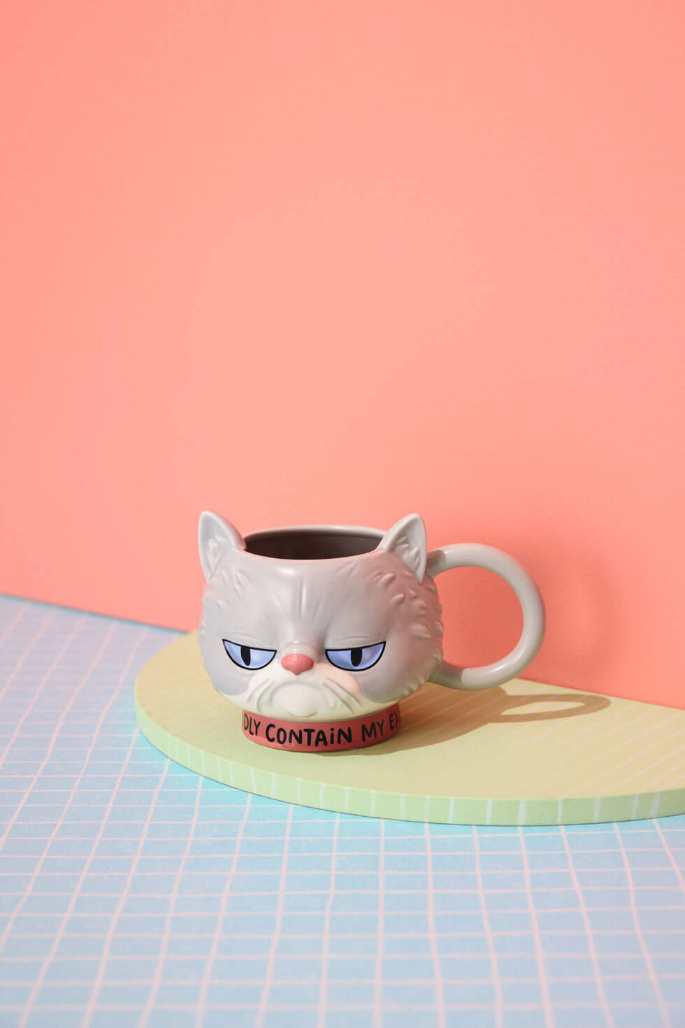 Hallmark Shoebox Sculpted Cat Mug, ceramic, grey, with an annoyed expression on a pastel platform.