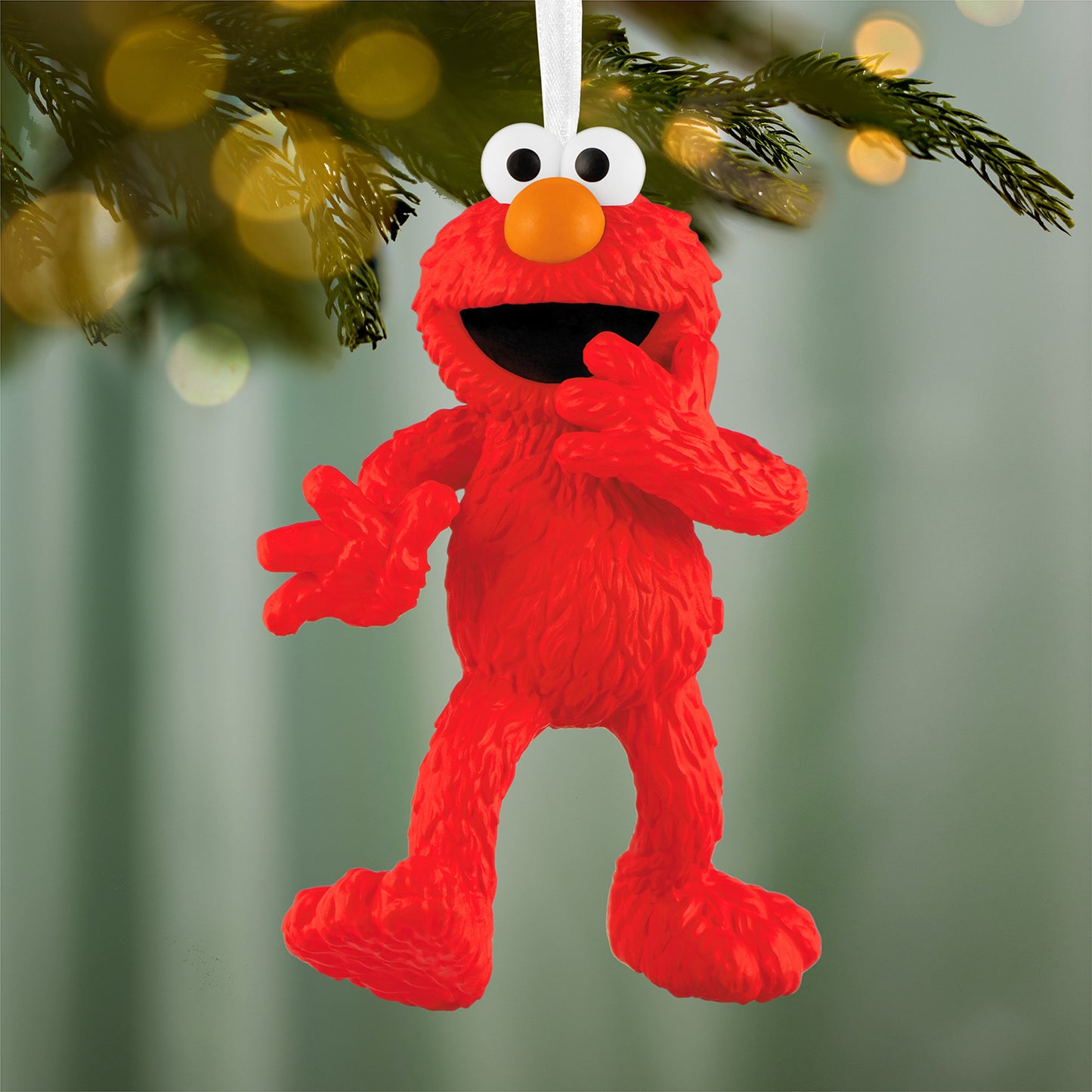 Sesame Street® 30th Anniversary Tickle Me Elmo With Motion-Activated Sound — 2026 Hallmark Keepsake Christmas Ornament hanging on a Christmas tree branch.