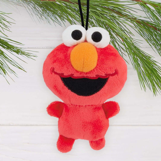 Sesame Street Elmo, Fabric - Hallmark Christmas Ornament in red plush with smiling face, hanging among pine branches.
