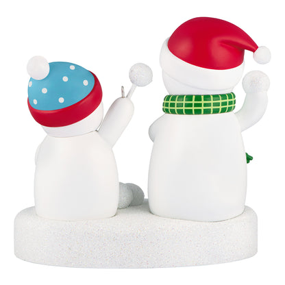 Snowball Fight 2026 Musical — 2026 Hallmark Keepsake Christmas Ornament features cheerful snowmen with playful hats, standing on a snowy base.
