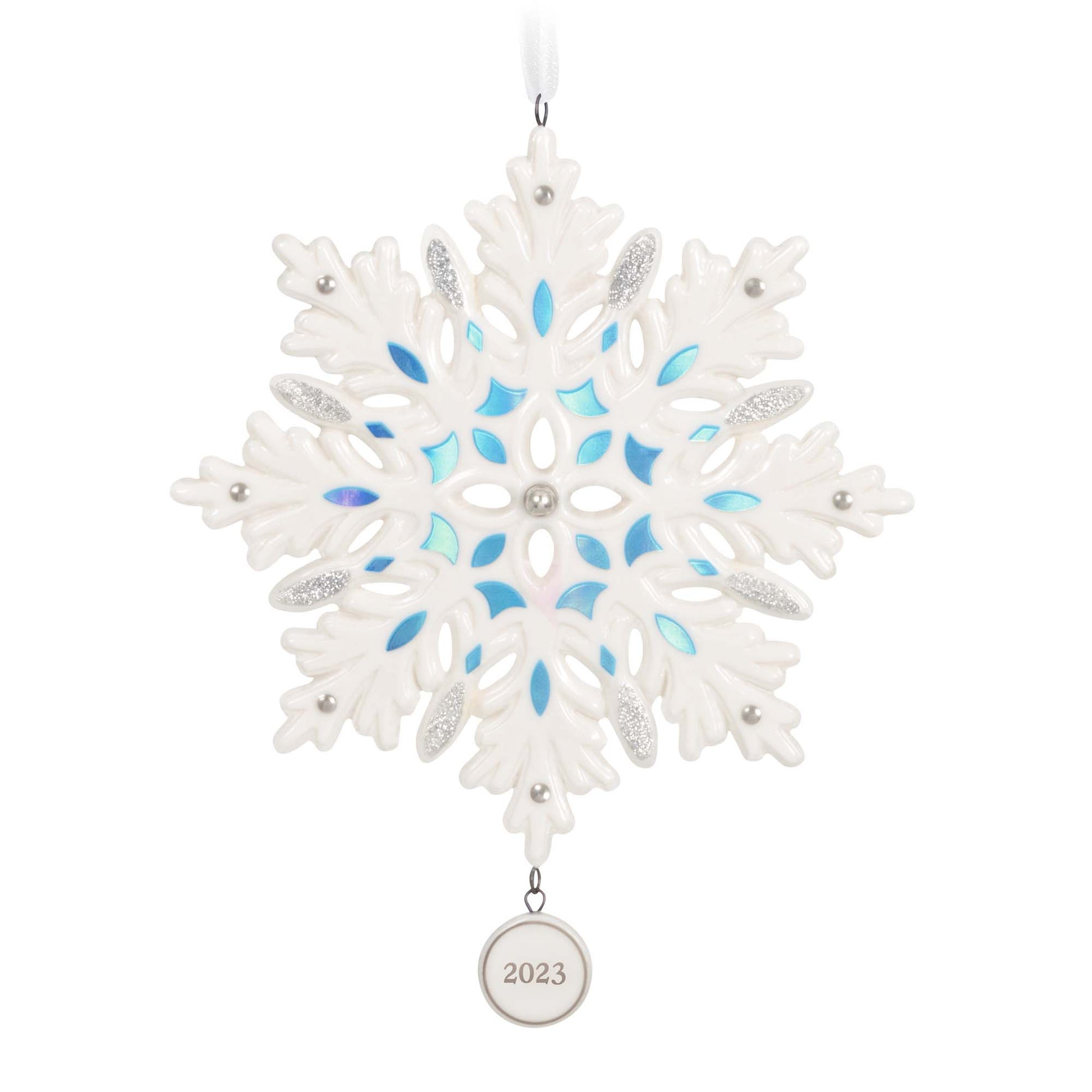 Snowflake (Porcelain) — 2023 Hallmark Keepsake Christmas Ornament with blue metallic accents and a 2023 date charm, flat lay view.