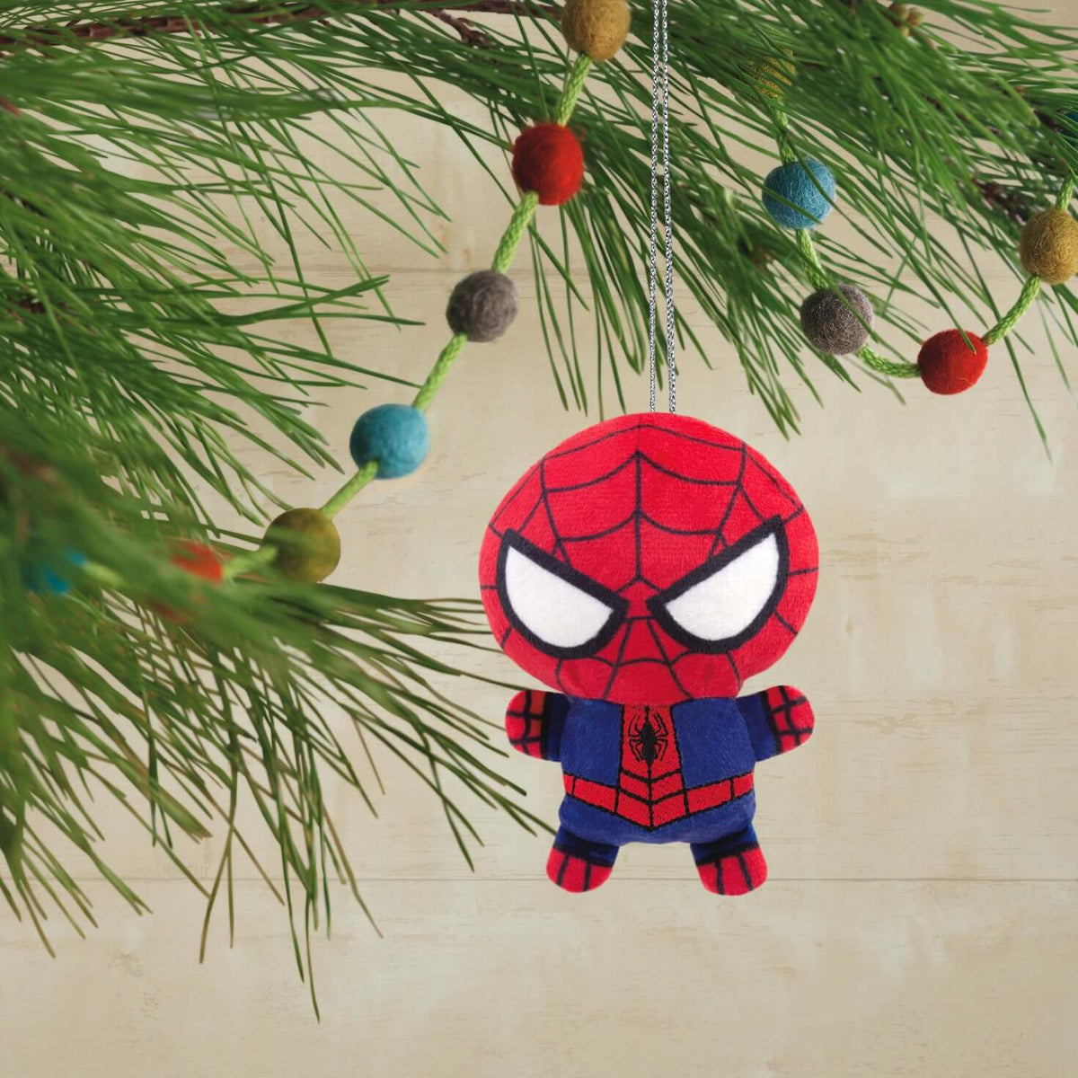 Marvel Spider-Man, plush fabric - Hallmark Christmas ornament, colourful design, hanging from a festive tree branch.