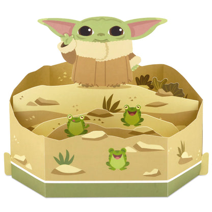 Hallmark Paper Wonder Star Wars™ Baby Yoda Pop Up Father's Day Card, Birthday Card, or Any Occasion (Reaching Out) with 3D diorama of Baby Yoda and frogs.