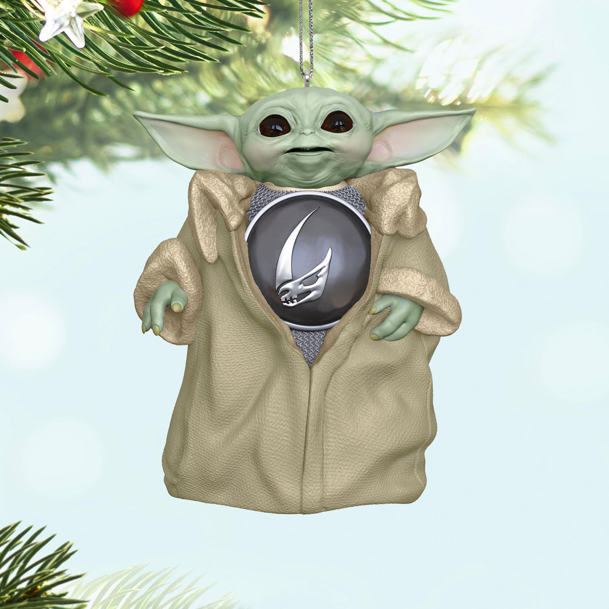 Star Wars™: The Mandalorian™, Din Grogu™ — 2025 Hallmark Keepsake Christmas Ornament, featuring a detailed Grogu in a light robe with a pendant, hanging on a Christmas tree.