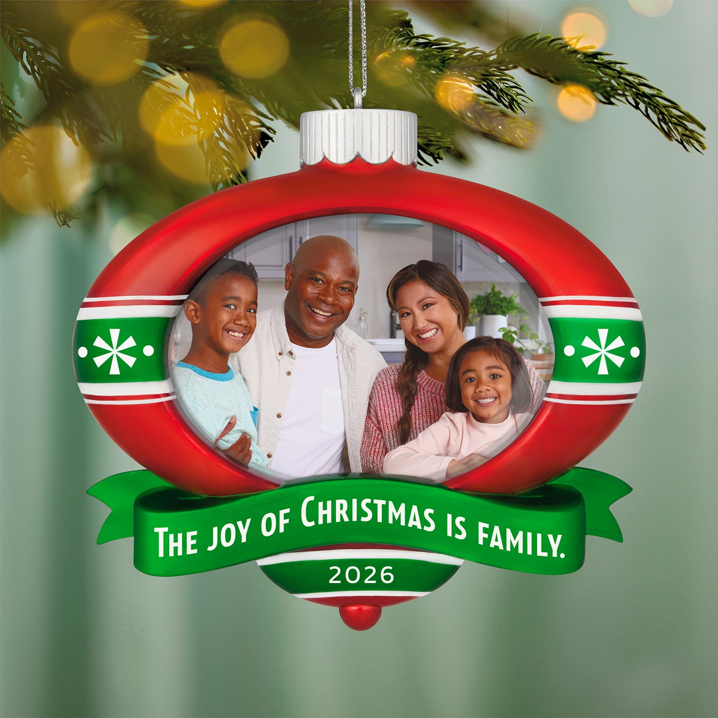 The Joy of Christmas 2026 Photo Frame — 2026 Hallmark Keepsake Christmas Ornament, red and green ornament with family photo holder, close up.