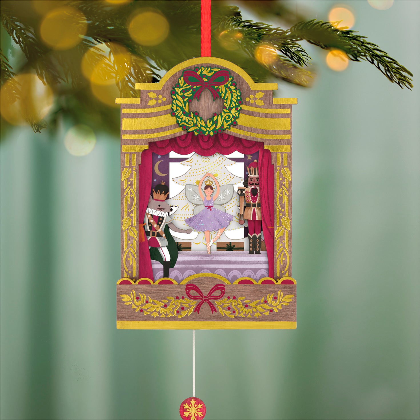 The Nutcracker Ballet Musical With Motion, Papercraft — 2026 Hallmark Keepsake Christmas Ornament, showcasing intricate stage details with figurines, hanging on a Christmas tree.