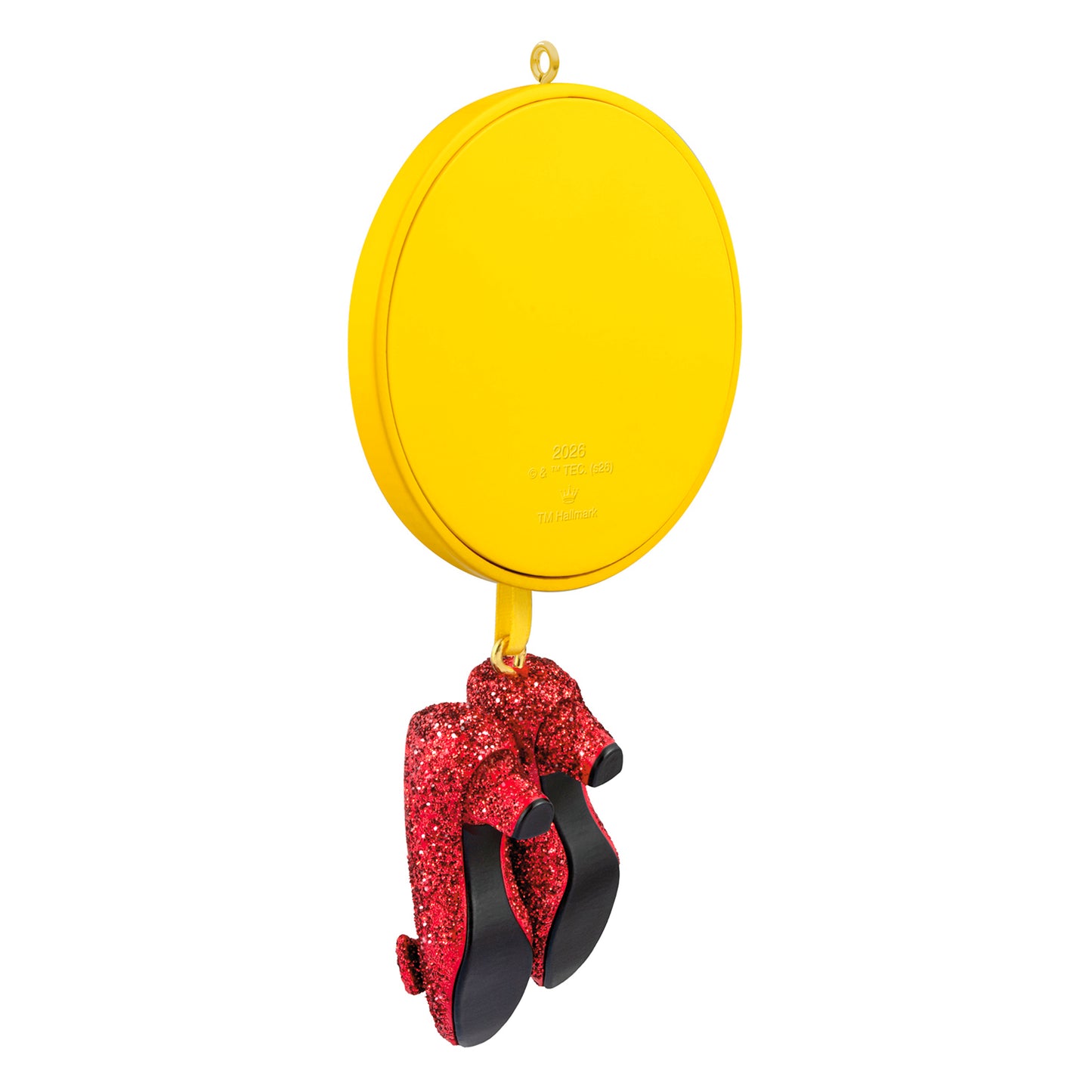 The Wizard of Oz™ Ruby Slippers — 2026 Hallmark Keepsake Christmas Ornament featuring glittery red slippers on a yellow ribbon with a round medallion.