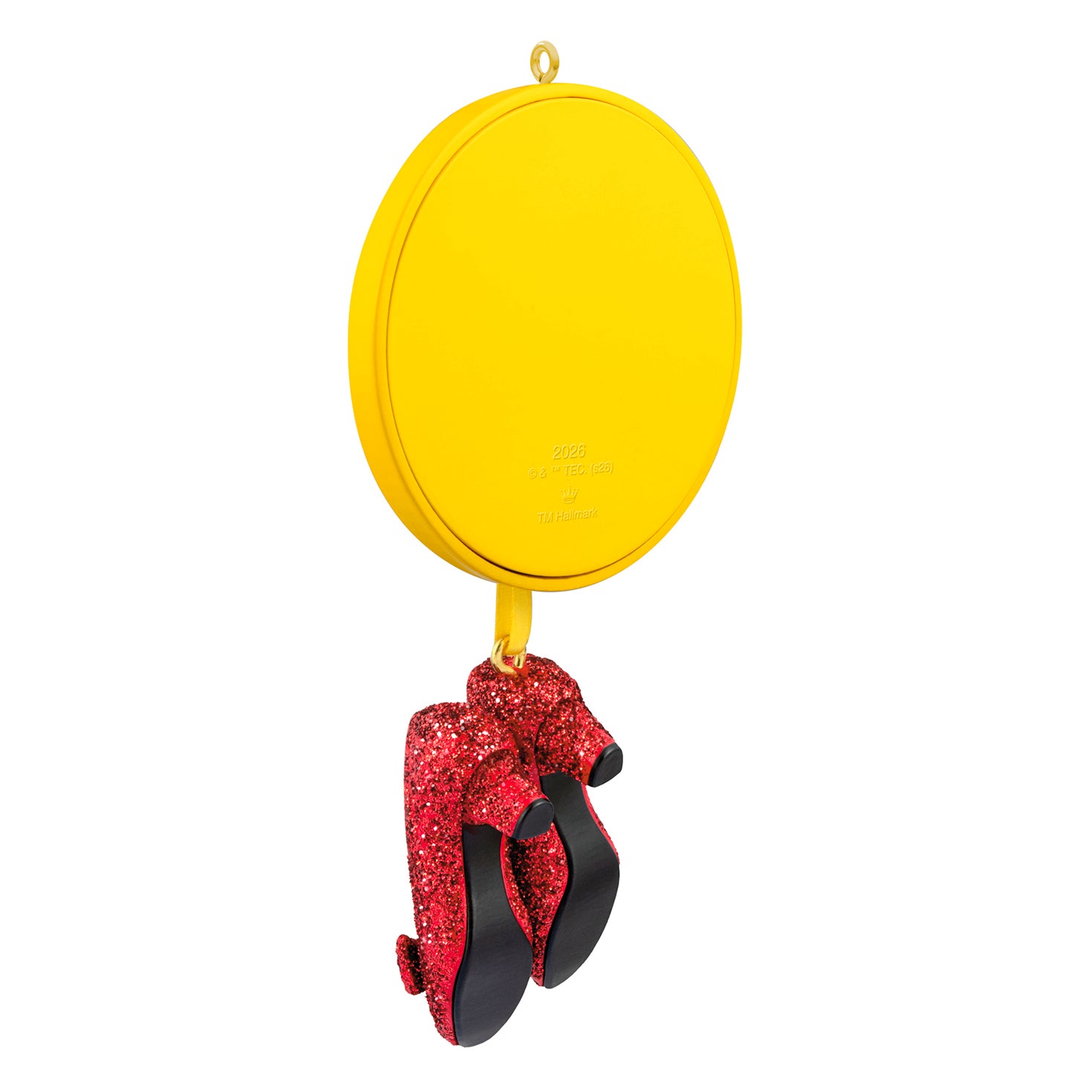 The Wizard of Oz™ Ruby Slippers — 2026 Hallmark Keepsake Christmas Ornament featuring glittery red slippers on a yellow ribbon with a round medallion.