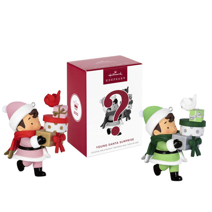 2025 Young Santa Surprise Box — 2025 Hallmark Keepsake Christmas Ornament with two figures in festive outfits and surprise packaging.
