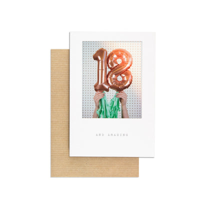 Contemporary Polaroid Balloon 18th Birthday Card featuring rose gold foil balloons and green tassels, flat lay view with kraft envelope.