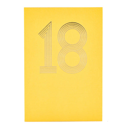 Signature Studio 18th Birthday Card - Wishing You Happiness! embossed yellow card with gold foil '18' design in a flat lay view.