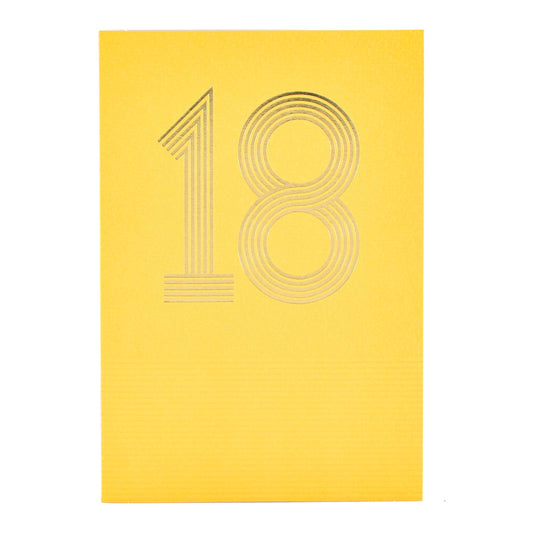 Signature Studio 18th Birthday Card - Wishing You Happiness! embossed yellow card with gold foil '18' design in a flat lay view.