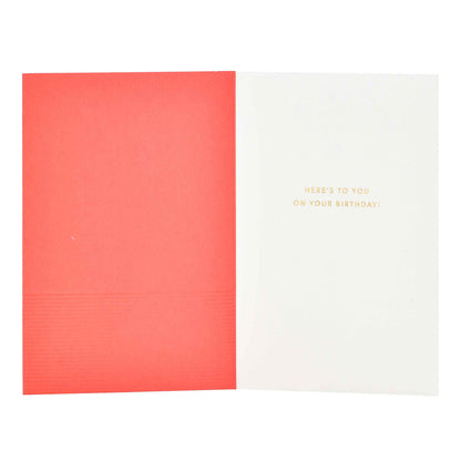 Signature Studio 21st Birthday Card - Here's To You! opened view, featuring embossed gold letters and coral tones in the interior.