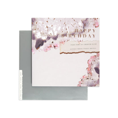 Elegant Agate Crystal Birthday Card with rose gold foil and floral design, flat lay with silver envelope.