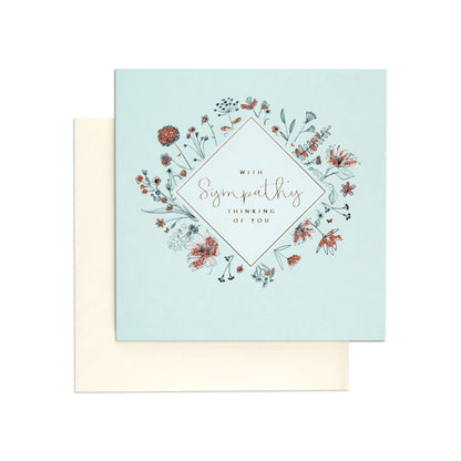 Thinking of Elegant You Sympathy Card featuring delicate flower illustrations, rose gold details, and a soft baby blue background.