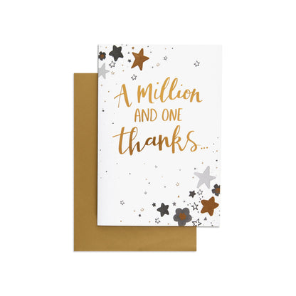 A Million and One Beautiful Thank You Card featuring gold foil text and floral star illustrations, flat lay with brown envelope.