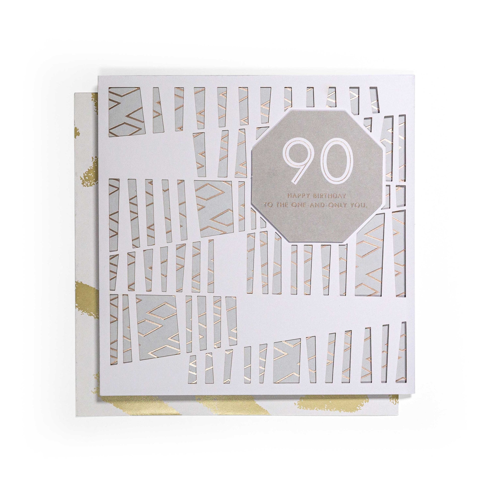 Contemporary Gold 90th Birthday Card featuring a 3D laser-cut overlay and gold foil highlights, flat lay view.