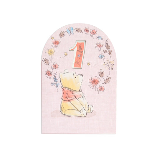 Lovely Disney Winnie The Pooh Sweet As Honey 1st Birthday Card featuring Pooh beside a cut-out '1' and floral designs in pastel colours.
