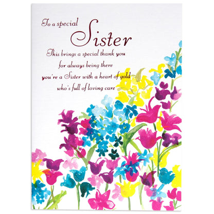 Special Sister Sweet Birthday Card featuring vibrant floral watercolour artwork with handwritten message, flat lay view.
