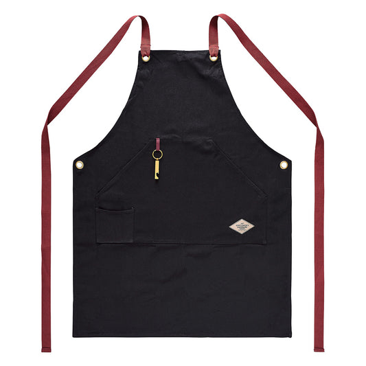 Utility apron & bottle opener in black cotton canvas with red straps, featuring a bottle opener and front pocket, flat lay view.