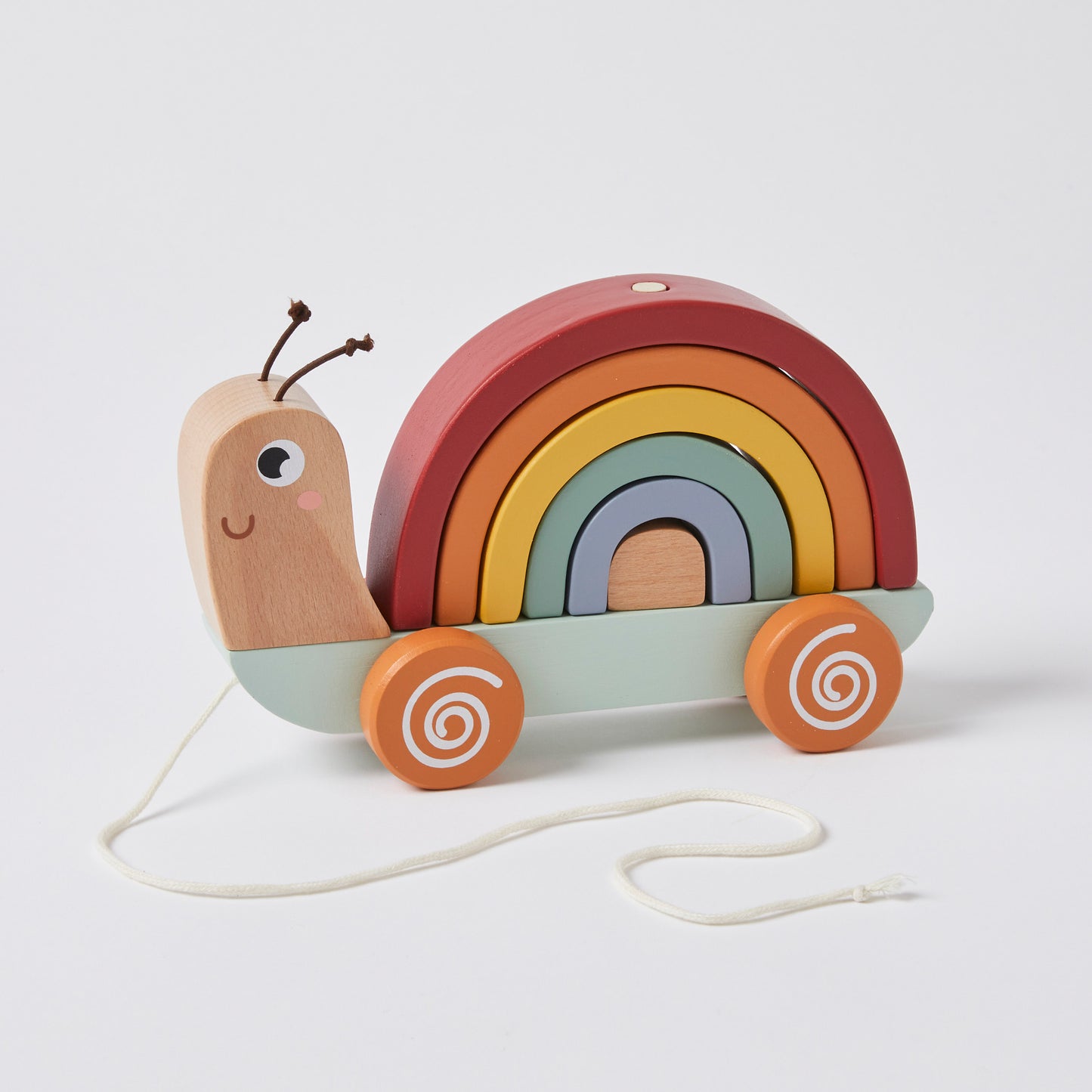 Pull along snail toy made from natural wood, featuring a rainbow shell and colourful wheels, presented on a plain background.