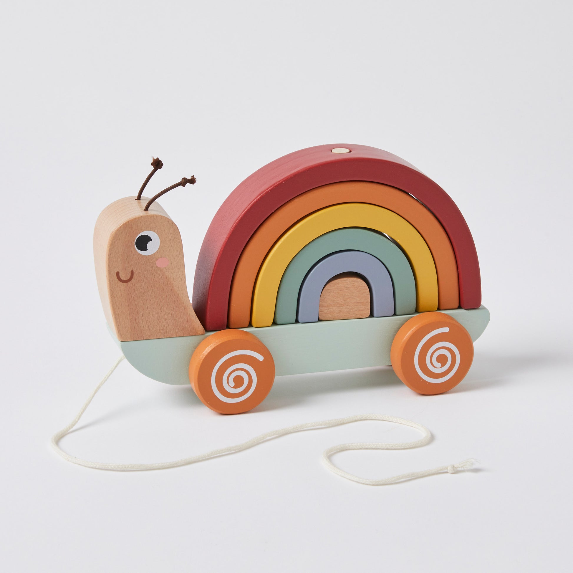 Pull along snail toy made from natural wood, featuring a rainbow shell and colourful wheels, presented on a plain background.
