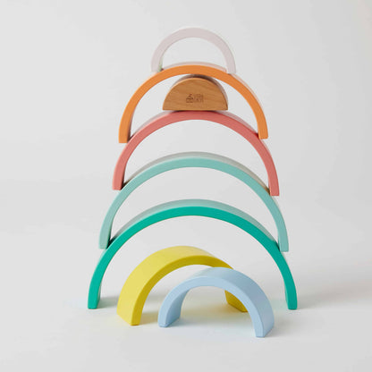 Rainbow Stacker wooden toy in pastel colours, showcasing stacked semi-circular shapes against a neutral background.