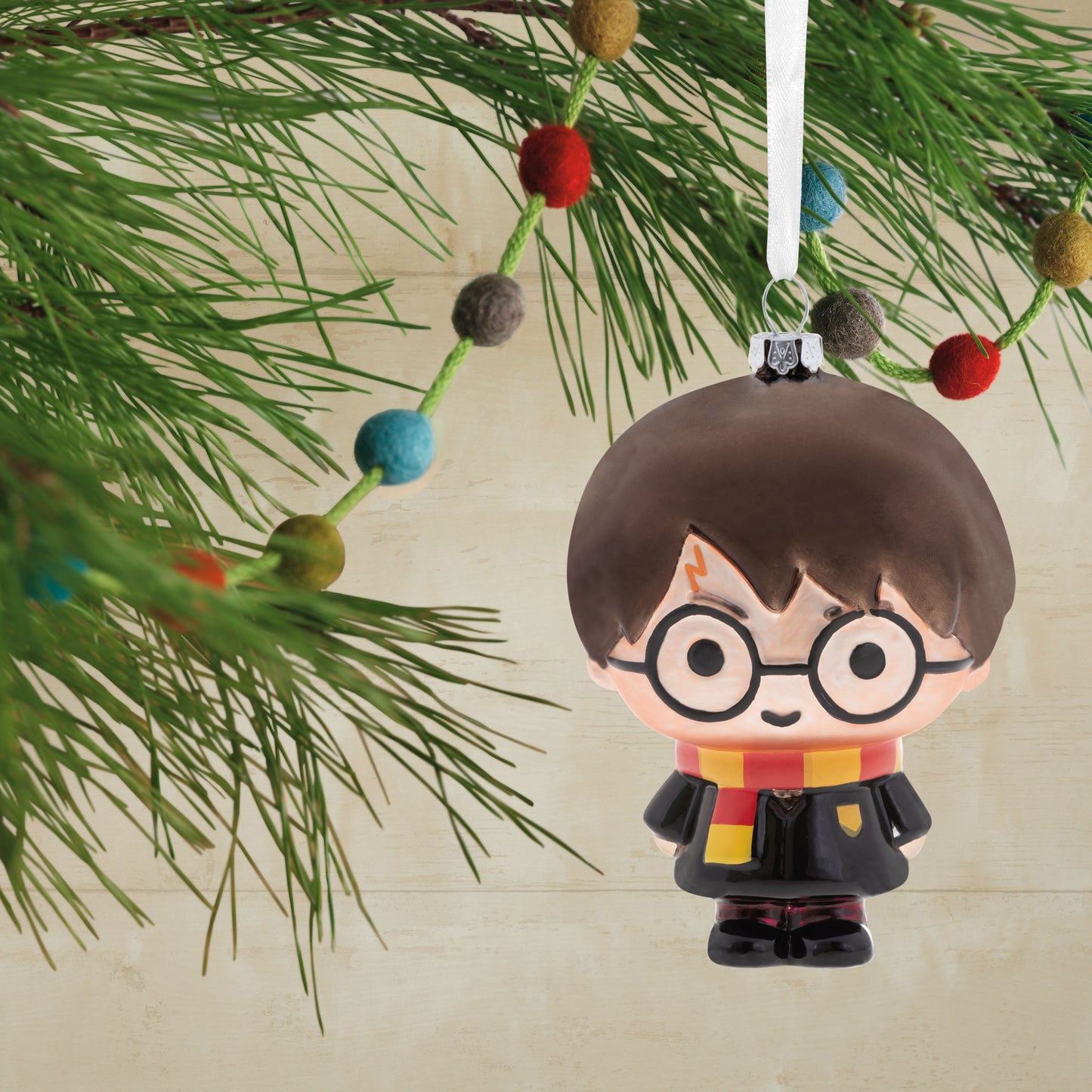 Harry Potter - Hallmark Glass Christmas Ornament in blown glass, featuring a stylised design of Harry with glasses, hanging on a Christmas tree.