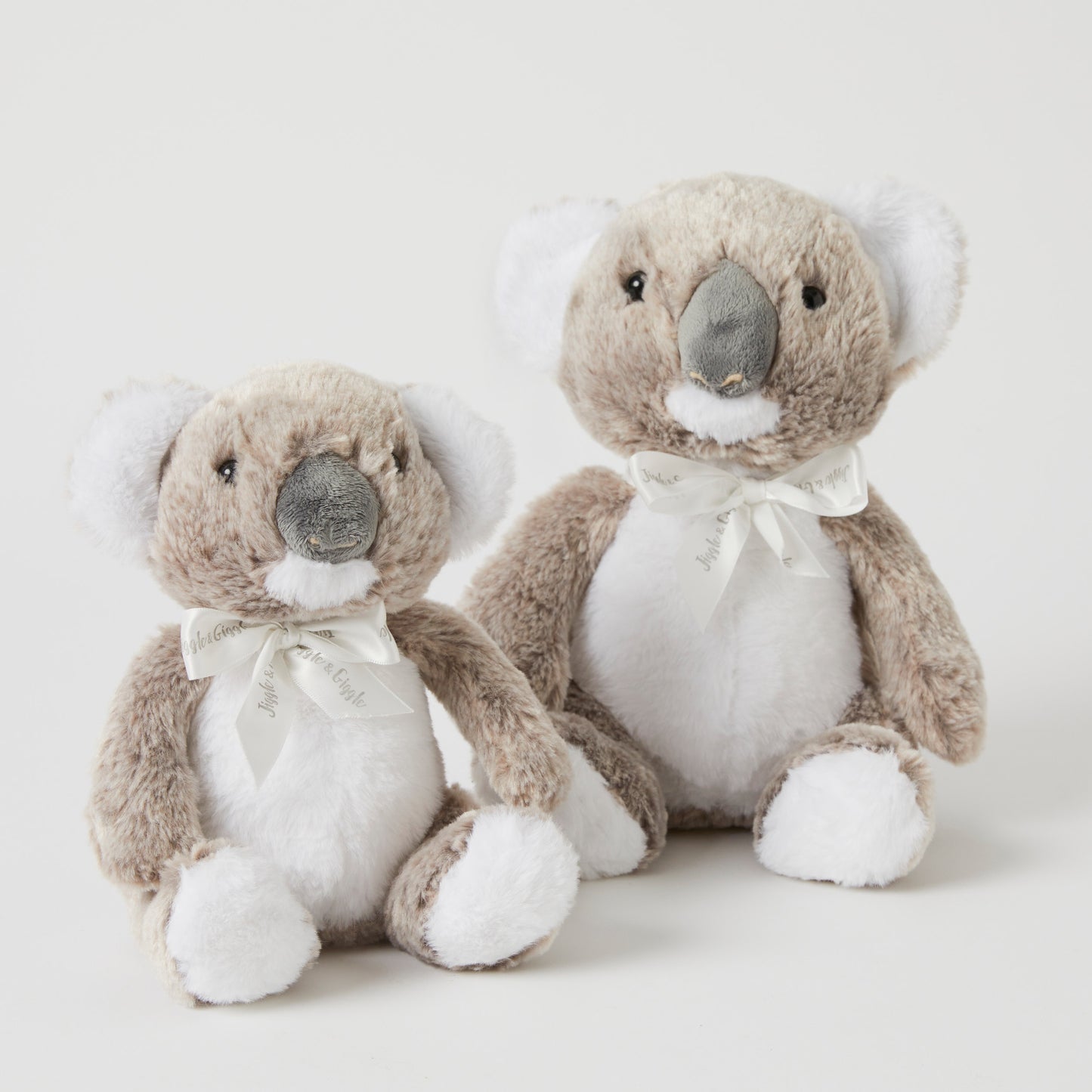 The Koala Family Set Of 2 plush toys, featuring small and large koalas with grey fur and white accents in a flat lay arrangement.