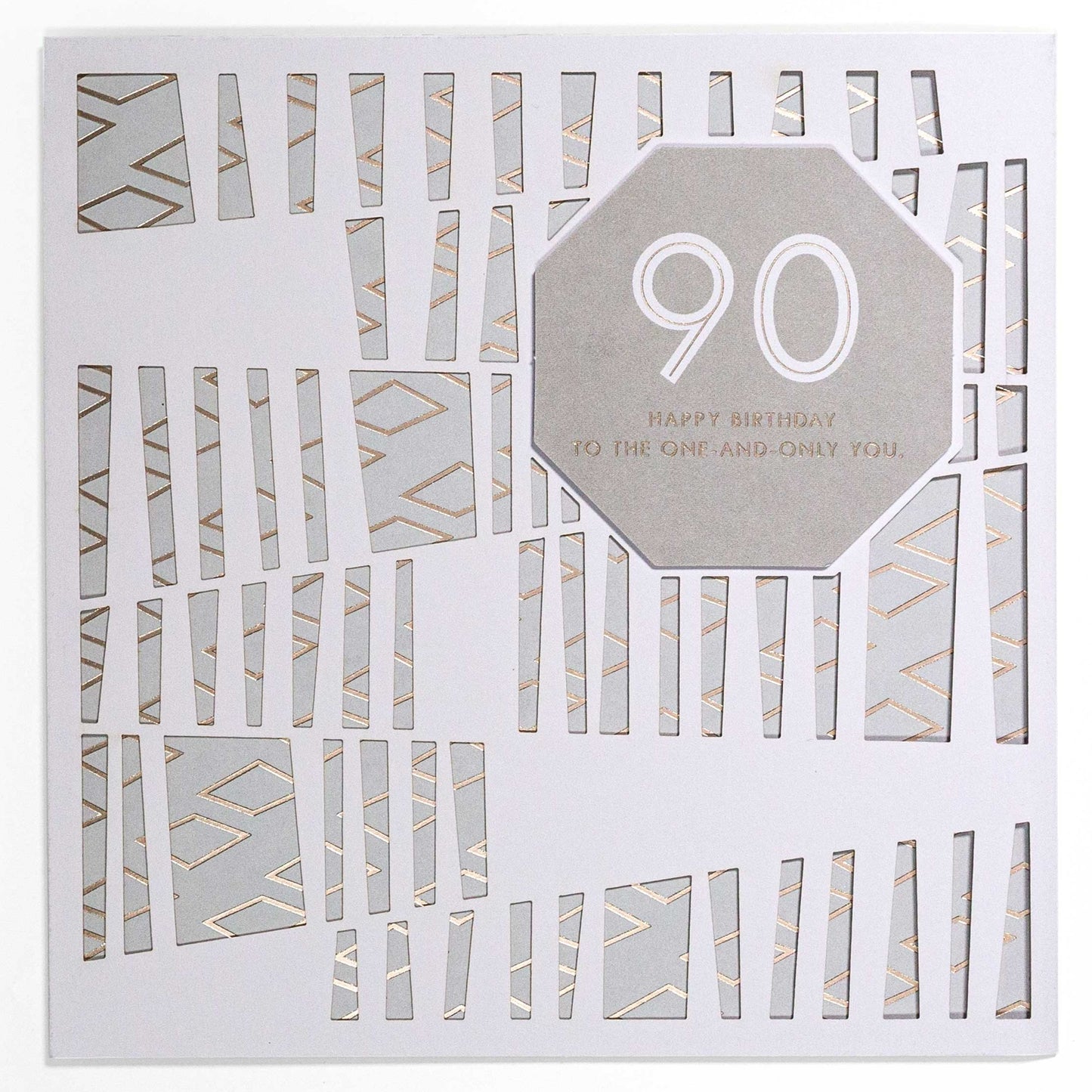 Contemporary Gold 90th Birthday Card with laser-cut design, geometric details, and gold foil highlights, flat lay view.